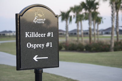 Black granite directional sign with custom aluminum framing