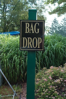 cast bronze bag drop sign 