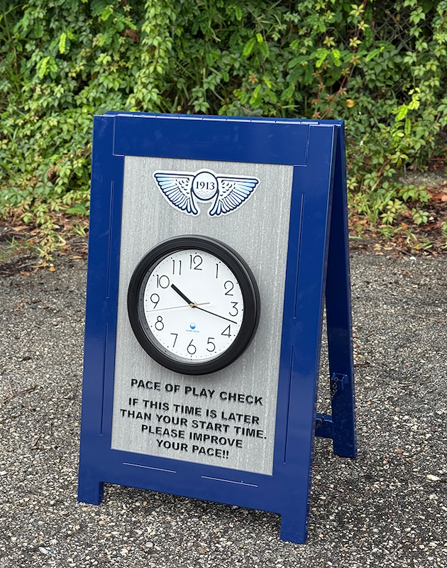 a frame sign with clock, logo and routed wording